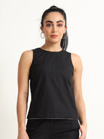 Organic Black cotton Closed neck sleeveless top with white piping detailing at the hem line.