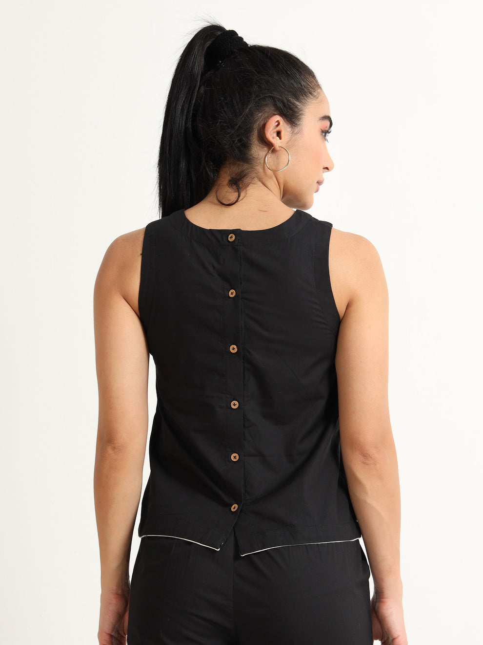 Organic Black cotton Closed neck sleeveless top with white piping detailing at the hem line.
