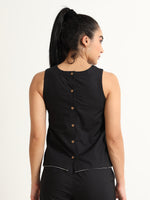 Organic Black cotton Closed neck sleeveless top with white piping detailing at the hem line.